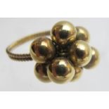 An 18ct 'gold ball' ring, size P,