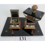 An Art Deco desk stand and blotter, made of black and clear glass with brass mounts,