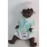 An early 20th century Armand Marseille black doll, with body and clothing, 60cm high,