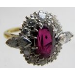 An 18ct gold ruby and diamond ring, having ten brilliant cut diamonds and two marquise cut,