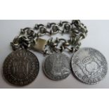 Three 18th century Spanish white metal coins, soldered and suspended onto a white metal bracelet,