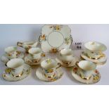 A Tuscan Art Deco china tea service, with bright floral design on an ivory ground,