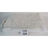 Two white bed throws, one crochet type pattern, the other embroidered linen,