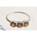 A 9ct white gold three stone topaz ring, size R,