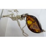 An amber pendant stamped 925, on a fine chain, clasp marked 925, boxed,