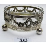 A white metal jam dish decorated with swags and flowers, with glass liner,