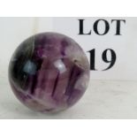 A polished marble spherical ornament, 6cm diameter,