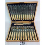 An Edwardian inlaid walnut canteen of 12 bone handled knives and forks and servers,