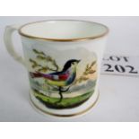 An early English mug with a colourful bird one side and walkers on the other, 7.