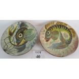 Two stylish chargers, hand painted and signed verso, both decorated with fish, 32cm diameter,