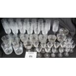 A large quantity of cut glass drinking glasses, including 14 champagne flutes, six wine glasses,