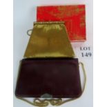 A Christian Dior vintage evening bag in burgundy with gilt strap and a gold mesh evening bag with