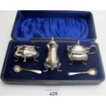 A thee piece silver condiment set, Birmingham 1922 and 1925, with blue liners,