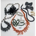 An assortment of costume jewellery to include a coral necklace,