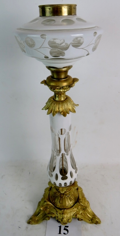 A good quality 19th century Bohemian opaque-flashed glass oil lamp with lavish gilt metal mounts,