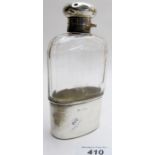 A panel cut hip flask with silver top and silver beaker, London 1914,