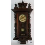A late 19th century continental Vienna type wall clock, with carved outer case, 81cm tall,