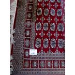 A 20th century part silk Persian carpet on claret ground, slightly a/f, (72" x 115" approx),