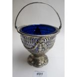 A Victorian silver pedestal sugar bowl with swing handle and pierced decoration, blue liner,
