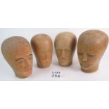 Four antique carved wooden Milliners heads, tallest 24cm,
