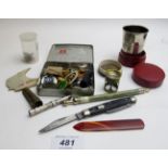 An assortment of items to include badges, medallion, travelling beaker and quartz paper knife,