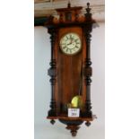 A 19th century Vienna-type glazed walnut cased wall clock, with architectural pediment,