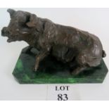 A signed bronze of a pig on a green marble base,