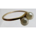 A 9ct gold ring set with two pearls, size I,
