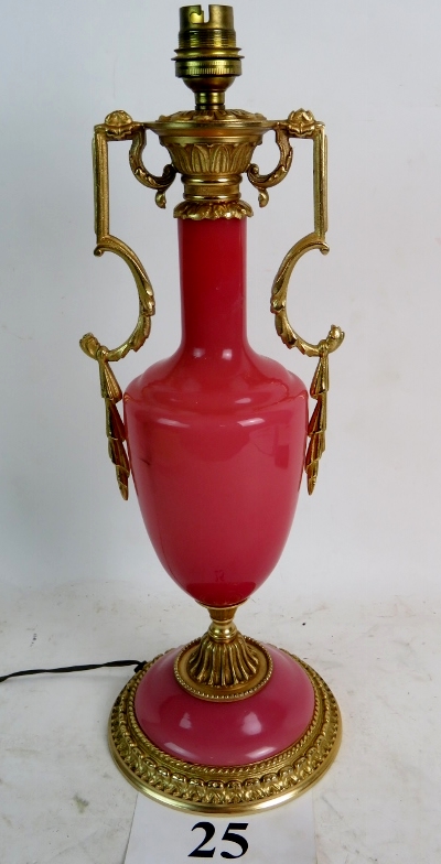 An ornate Classical-Revival gilt-metal and pink glass table lamp, 40cm high,