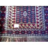A 20th century Afghan rug on deep red ground,