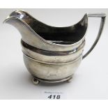 A Georgian silver cream jug on ball feet, (a/f), approx 4 troy oz/135 grams,