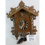 A Black Forest cuckoo clock, decorative carved wooden case, signed movement striking on a gong,