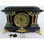 A highly decorative mantle clock with ormolon fittings, faux marble and lacquered wood case,