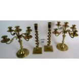 A pair of late 19th/early 20th century spiral twist brass candlesticks and a pair of later four