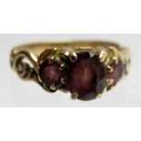 A 9ct gold three stone amethyst ring, size L,