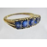 An 18ct gold ring set with five graduated sapphires, size N,