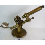 A lacquered brass microscope, with ratchet adjuster, oval base, approx.