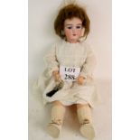 An early 20th century German bisque head doll, `390 AIOM`, with blue glass sleeping eyes,