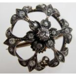 A diamond brooch/pendant comprising of 25 diamonds, centre diamond approx 1/2ct,
