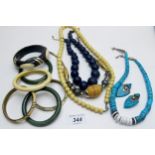 A collection of ivory and other bracelets, a turquoise coloured necklace and earrings,