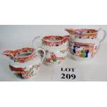 Three early English graduated jugs decorated in orange and blue, in a Chinoiserie pattern,