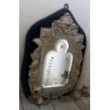 An ornate oval Girandole wall mirror in cast metal, with velvet mounts,