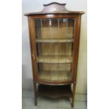 An Edwardian inlaid mahogany display cabinet with bow front leaded and glazed door and 3 internal