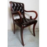 A 20th century mahogany armchair/desk chair upholstered in deep Burgundy buttoned leather with