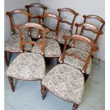 A set of 8 Victorian rosewood dining chairs with a tapestry style material over turned legs,