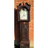 A 19th century carved oak 8 day longcase clock with painted arched moon phase dial and complete