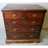 An 18th century oak country chest of 2 short over 3 long drawers with brass handles and escutcheons,