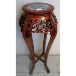 A late 19th/early 20th century Chinese jardiniere stand with an inset marble top,