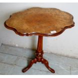 A small Victorian walnut occasional/side table with a shaped and figured top over a reeded column