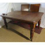 A Victorian oak windout dining table with 2 extra leaves over reeded legs and castors,